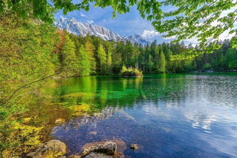 Lake Badersee in spring with Zugspitze group 2962m in the Wetterstein mountains, Zugspitz village