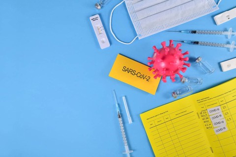 Corona Virus flatlay with vaccine passport, serums, vials and tests