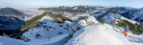 Hiker in winter climbing the Aiplspitz, winter, Alpine panorama with Aiplspitz, Schliersee and