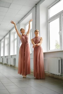 Two ballet dancers rehearsing choreography in the hallway