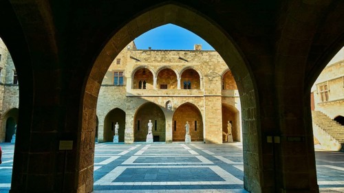 Sunlit inner courtyard of a castle with symmetrical shadow plays, archway, inner courtyard, Grand