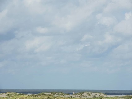 Lonely coastal area with cloudy sky and sea view, lonely beach with dune grass in the neighbouring
