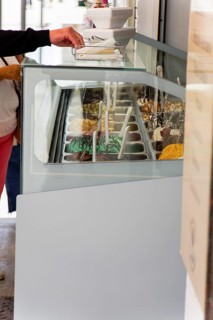 Customers buying ice cream in an ice cream parlor on the street