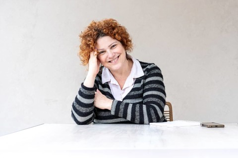 Portrait of a beautiful mid-adult redhead woman looking at the camera