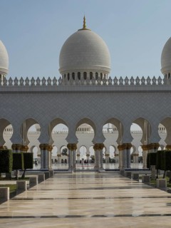 Large mosque arcades and domes, supported by impressive arches in daylight, beautiful mosque with