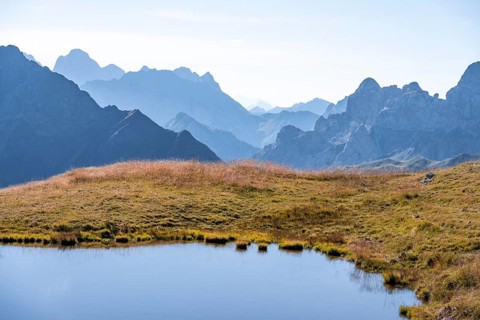 Mountain lake in front of mountain landscape, silhouettes of rocky mountain peaks, Luggauer Toerl,