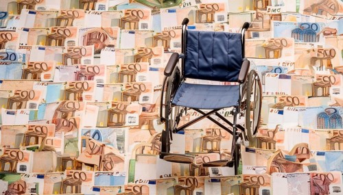 Symbolic long-term care insurance, care costs, disability, a wheelchair stands on a surface of euro