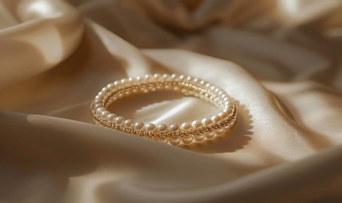 A pearl bangle bracelet with intricate detailing laid out on a smooth satin material background AI