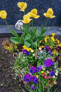 Grave with floral decoration and cherub at the cemetery church of St Stephan, Irsee, Swabia,