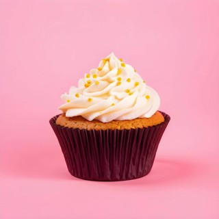 Cupcake with swirls of buttercream frosting in vanilla against pastel pink background, AI generated