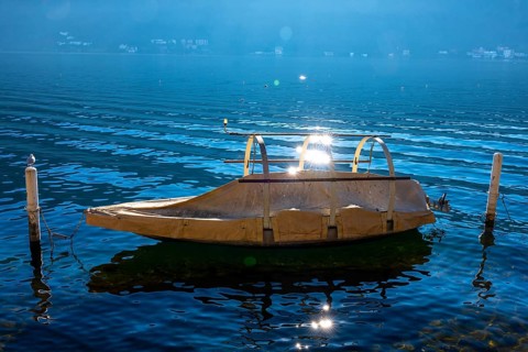 Beautiful Old Fishing Boat on Lake Lugano with Sun Reflection in a Sunny Day in Morcote, Ticino,