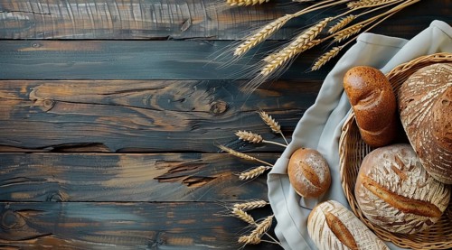 Variety of fresh loaf of bread and wheat on a rustic table with a lot of copy space, AI generated