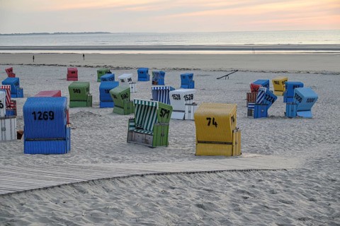A cool beach evening with colourful beach chairs, a wooden walkway and a quiet atmosphere, lots of
