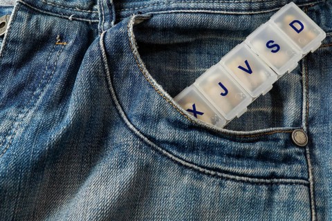 Jeans with a pillbox coming out of the pocket