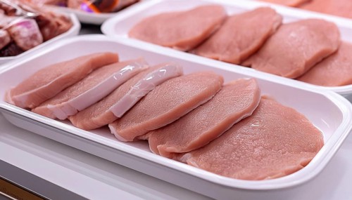 Meat, raw pork, schnitzel, in a display of a butcher's shop, AI generated, AI generated