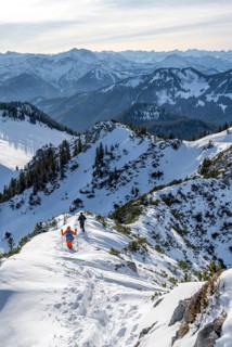 Hikers in winter descending the Aiplspitz, Mangfall mountains, Bavarian Prealps, Bavaria, Tyrol,