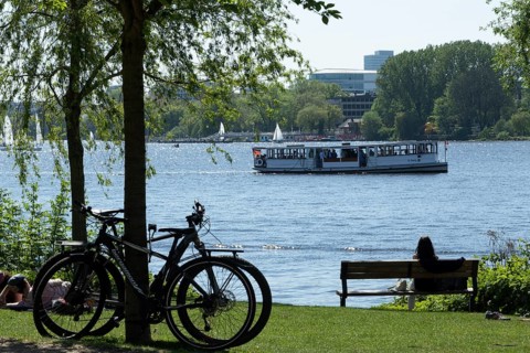 Symbolic image weather, leisure activity, summer spring, silhouette of bicycles and a woman on a