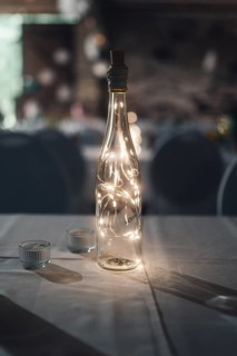 A light bulb in a bottle on a table creates a cosy atmosphere. Koblenz, Germany, Europe