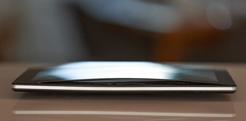 A defective, swollen battery pushes the housing of a tablet apart, damaging the display