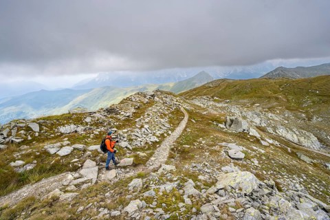Mountaineers on a hiking trail descending to the Obstanserseehuette, Carnic Main Ridge, Carnic High