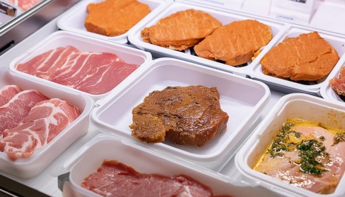 Meat, raw pork, schnitzel and steak, marinated and seasoned, in a display in a butcher's shop, AI