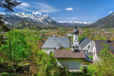 Pilgrimage church St. Anton in spring above the village in front of the Zugspitze group 2962m in