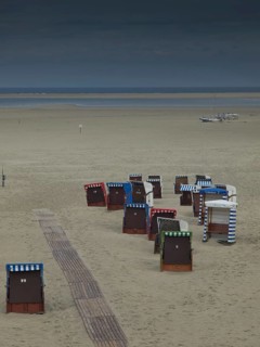 Group of beach chairs on empty, cool beach, cloudy sky and calm atmosphere, beach chairs and beach