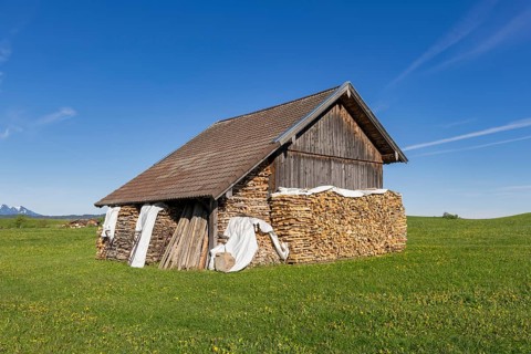 Wooden hut near Fuessen, woodpile, Allgaeu Alps, snow, meadow, Allgaeu, Bavaria, Germany, Europe