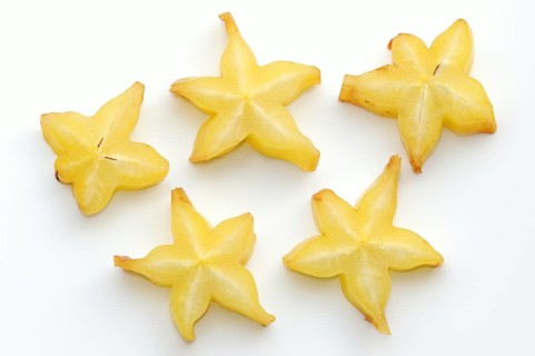 Star fruit or carambola (Averrhoa carambola), sliced fruit on a white background