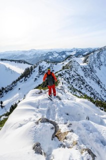 Mountaineer on the ridge of the Aiplspitz in the snow, snow-covered mountain landscape with
