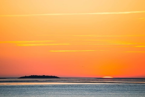 Picturesque, golden, breathtakingly beautiful sunset over the sea, last moments in front of the sun