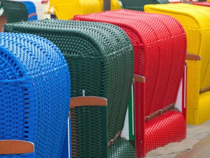 Close-up of colourful beach chairs in different colours arranged on the beach, beach chairs and