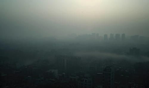 Urban landscape shrouded in smog with tall buildings barely visible AI generated