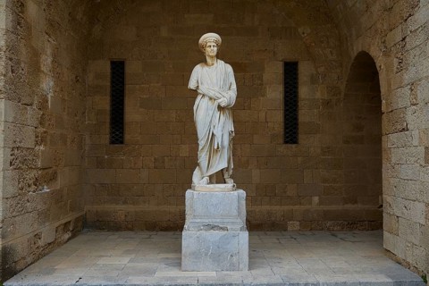 Full view of a statue on a column in historical context, statue from the island of Kos, courtyard,