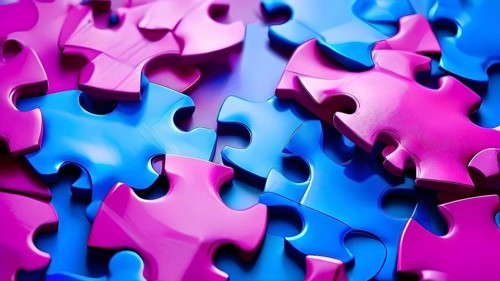 Illustration of scattered blue and magenta puzzle pieces sprawled across as a wallpaper background,