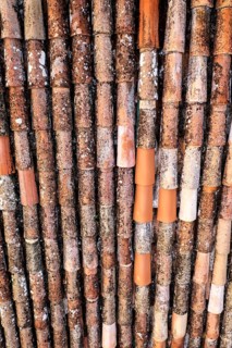 Close-up of several worn and rusty pipes in brown and orange tones
