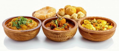 Vibrant colored Indian curries and lentils served in matching wooden bowls, showcasing gourmet food