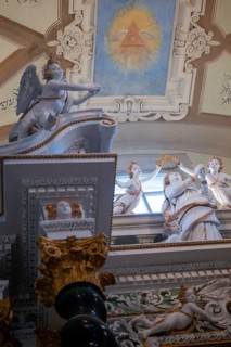 Statue and the Eye with Triangle Painted on the Ceiling with Window Light Inside the Church of San