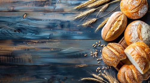 Variety of fresh loaf of bread and wheat on a rustic table with a lot of copy space, AI generated