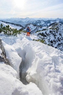 Hiker in winter climbing the Aiplspitz, Mangfall mountains, Bavarian Prealps, Bavaria, Tyrol,