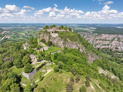 Aerial view of the Hohentwiel volcanic cone with Germany's largest fortress ruins, behind it the
