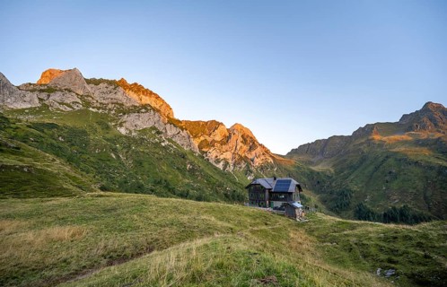 Alpine club hut, Hochweisssteinhaus mountain hut, mountain landscape with green mountain meadows