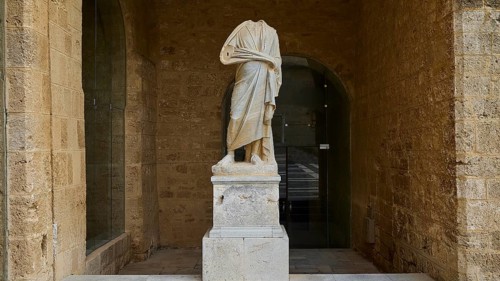 Statue without head and arms on a column in a niche, courtyard, torso of a Roman statue, Grand