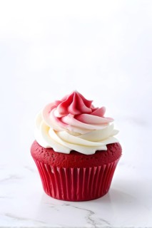 Cupcake with delicate icing swirls with a cherubic ruby red fondant decoration, AI generated