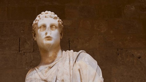 Close-up of an ancient marble statue with curly hair, 2nd century BC statue, courtyard, Grand