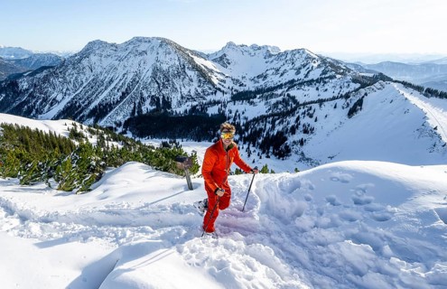 Mountaineer at the summit of the Aiplspitz in the snow, snow-covered mountain landscape with