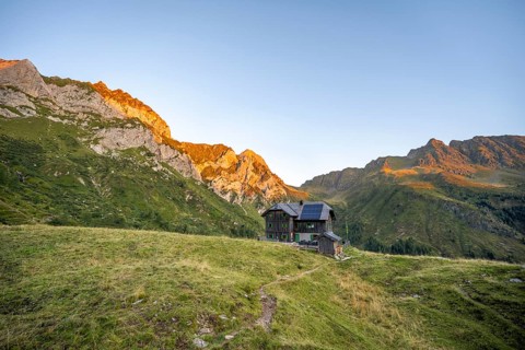 Alpine club hut, Hochweisssteinhaus mountain hut, mountain landscape with green mountain meadows