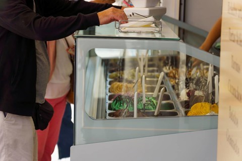 Customers buying ice cream in an ice cream parlor on the street