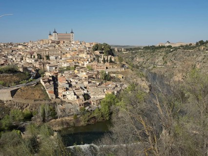 Panoramic view of a historic city on the river with characteristic buildings and church towers,