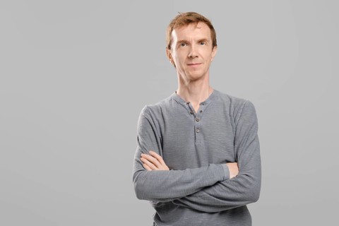 Studio portrait of middle aged man with crossed arms